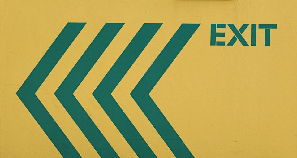 brand-expansion--a-yellow-building-with-a-green-arrow-symbolizing-growth