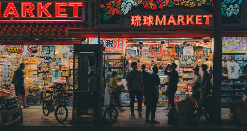 international-market-research--a-group-of-people-standing-outside-of-a-market