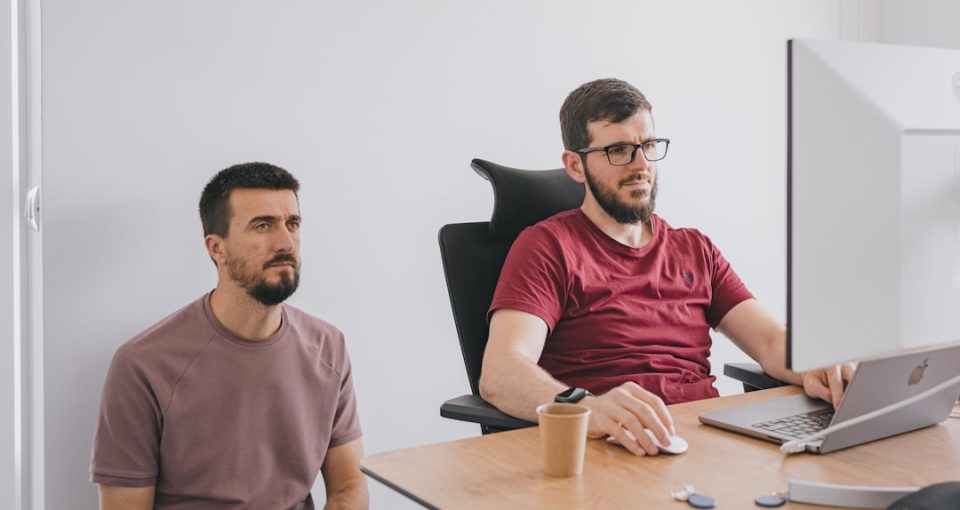 startup-support-services--two-men-sitting-at-a-table-with-a-laptop