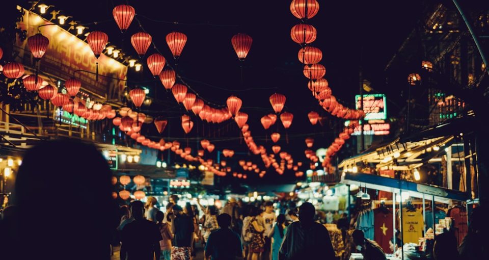 china-market-entry---people-walking-between-food-stalls-under-chinese-lanterns
