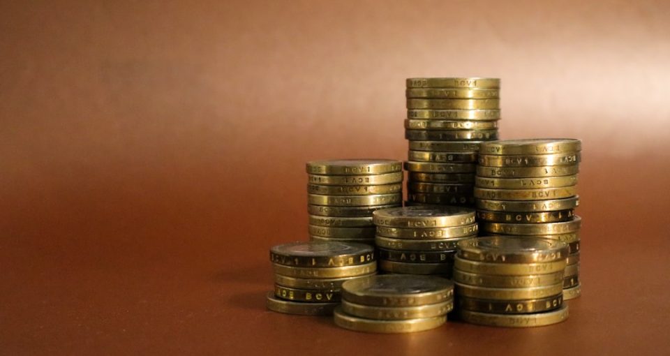 a-pile-of-gold-coins-sitting-on-top-of-a-table---entrepreneur-funding-support